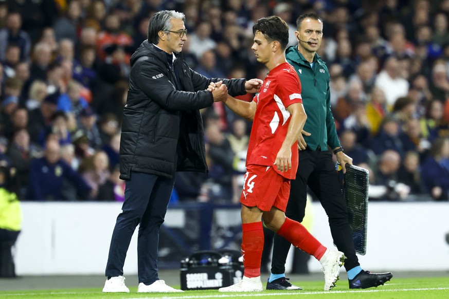 Switzerland's head coach Murat Yakin, left, cheers with Switzerland's Ardon Jashari, right, during the UEFA Nations League soccer match between Scotland and Switzerland at the Hampden Park i ...