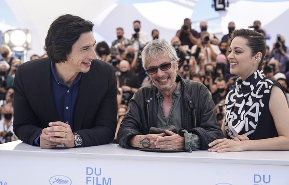 Adam Driver, from left, Marion Cotillard and director Leos Carax pose for photographers at the photo call for the film Annette at the 74th international film festival, Cannes, southern France, Tuesday ...