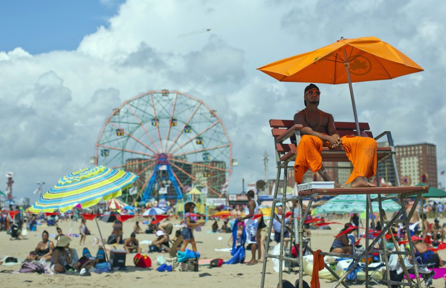 A lifeguard keeps an eye on swimmers at the beach on Coney Island in the Brooklyn borough of New York on Saturday, Aug. 20, 2016. (AP Photo/Mary Altaffer)