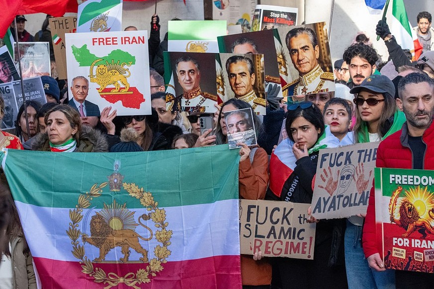 MANCHESTER, UNITED KINGDOM - 2026/01/24: (EDITOR'S NOTE: Image contains profanity)
Protesters are seen holding Iranian flags, portraits of Mohammad Reza Pahlavi, and anti-regime placards during t ...