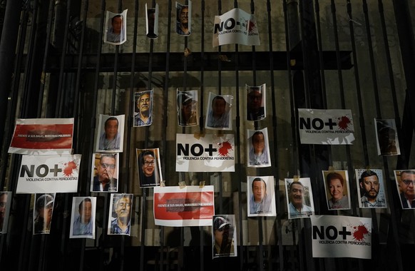 Photos of slain journalists are posted on the gate of Mexico&#039;s Attorney General&#039;s office during a vigil to protest the murder of journalist Heber Lopez, in Mexico City, Monday, Feb. 14, 2022 ...