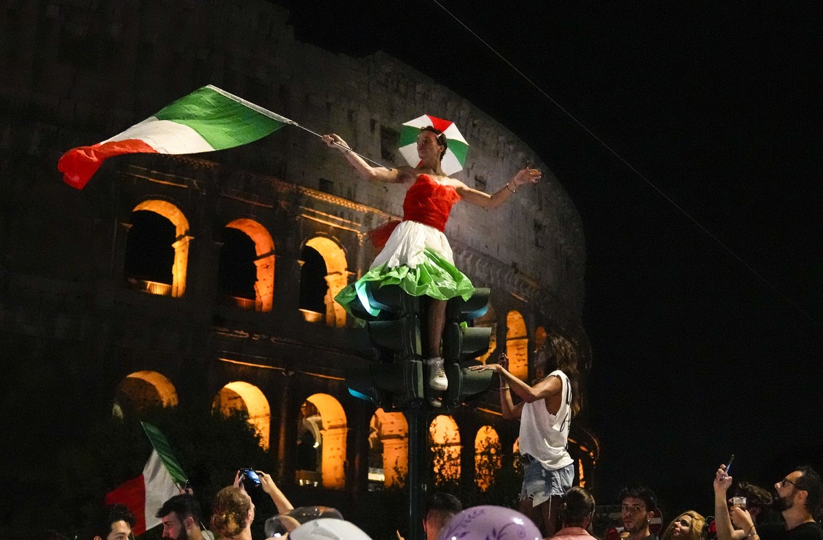 Italy's fans celebrate in Rome, Monday, July 12, 2021, after Italy beat England to win the Euro 2020 soccer championships in a final played at Wembley stadium in London. Italy beat England 3-2 in ...