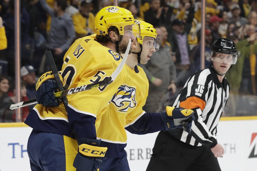 Nashville Predators&#039; Nick Bonino, center, celebrates with Roman Josi (59), of Switzerland, after Bonino scored a goal against the Edmonton Oilers in the second period of an NHL hockey game Monday ...