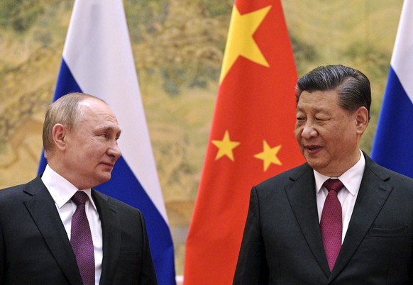 FILE - Chinese President Xi Jinping, right, and Russian President Vladimir Putin talk to each other during their meeting in Beijing, China on Feb. 4, 2022. China says President Xi will visit Russia fr ...