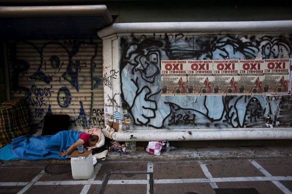 A homeless sleeps at the entrance of a closed store with posters reading &#039;&#039;No&#039;&#039; in central Athens, Monday, July 6, 2015. GreeceÂs Finance Minister Yanis Varoufakis has resigned fo ...