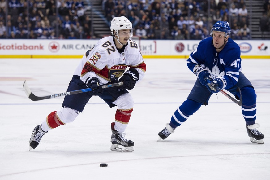 Toronto Maple Leafs center Leo Komarov (47) defends against Florida Panthers center Denis Malgin (62) during the third period of an NHL hockey game Tuesday, Feb. 20, 2018, in Toronto. (Christopher Kat ...