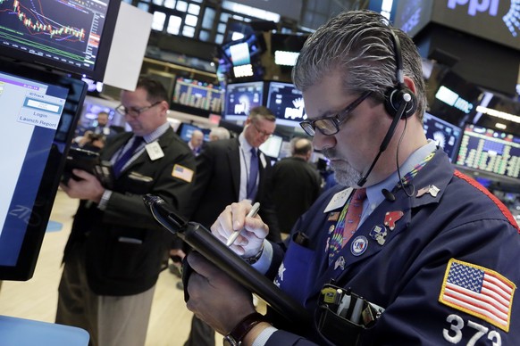 Trader John Panin, right, works on the floor of the New York Stock Exchange, Wednesday, April 19, 2017. U.S. stocks are rebounding Wednesday morning as strong results from Morgan Stanley and rising bo ...