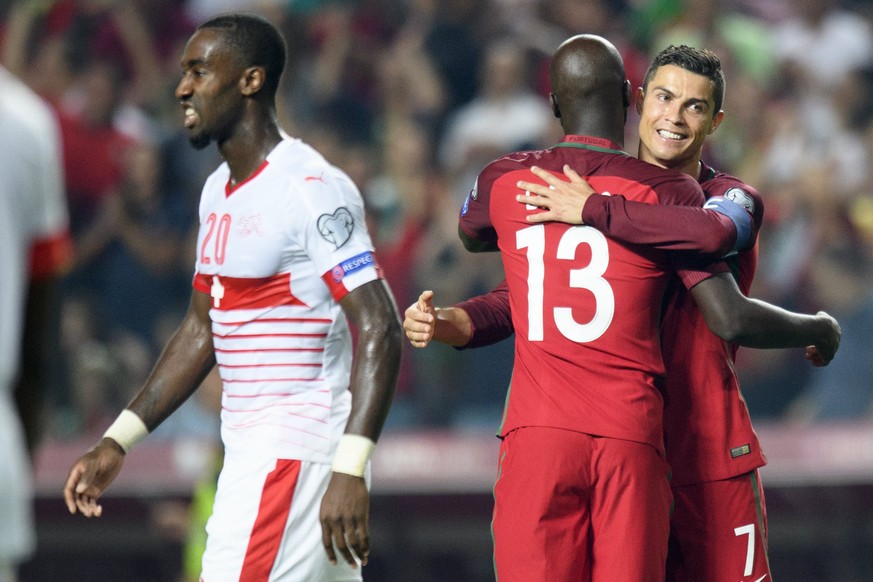 epa06257785 Switzerland&#039;s defender Johan Djourou, left, looks disappointed after loosing closes to the celebration of Portugal&#039;s midfielder Danilo Pereira, center, and Portugal&#039;s forwar ...