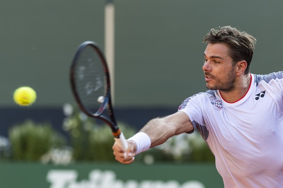 Stanislas &quot;Stan&quot; Wawrinka, of Switzerland, returns a ball to Damir Dzumhur, of Bosnia and Herzegovina, during their second round match, at the ATP 250 Geneva Open tournament in Geneva, Switz ...