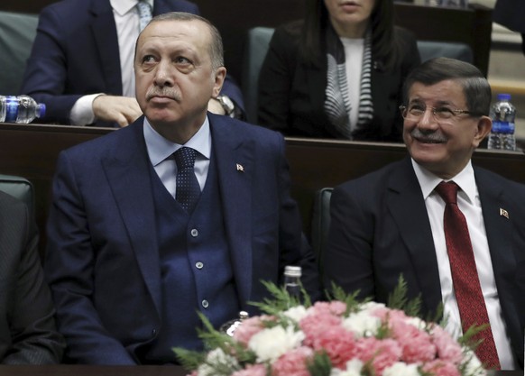 FILE - In this Jan. 30, 2018 file photo, Turkey&#039;s President Recep Tayyip Erdogan, left, and former Prime Minister Ahmet Davutoglu look toward the party members at the parliament in Ankara, Turkey ...