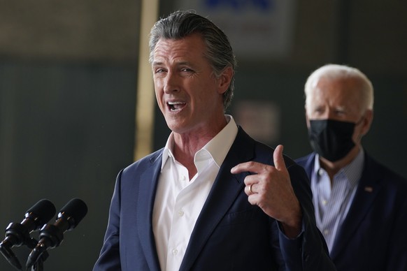President Joe Biden listens as California Gov. Gavin Newsom speaks about recent wildfires, at Sacramento Mather Airport, Monday, Sept. 13, 2021, in Mather, Calif. (AP Photo/Evan Vucci)
Joe Biden