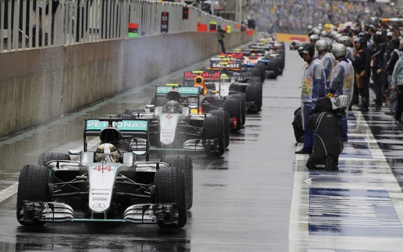 Formula One - F1 - Brazilian Grand Prix - Circuit of Interlagos, Sao Paulo, Brazil - 13/11/2016 - Mercedes&#039; Lewis Hamilton of Britain (44) leads other cars in the pit area during a pause in racin ...