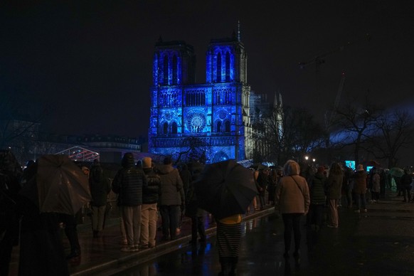 Spectators gather outside France&#039;s iconic Notre Dame Cathedral Saturday, Dec. 7, 2024 in Paris during it&#039;s formal reopening for the first time since a devastating fire nearly destroyed the 8 ...