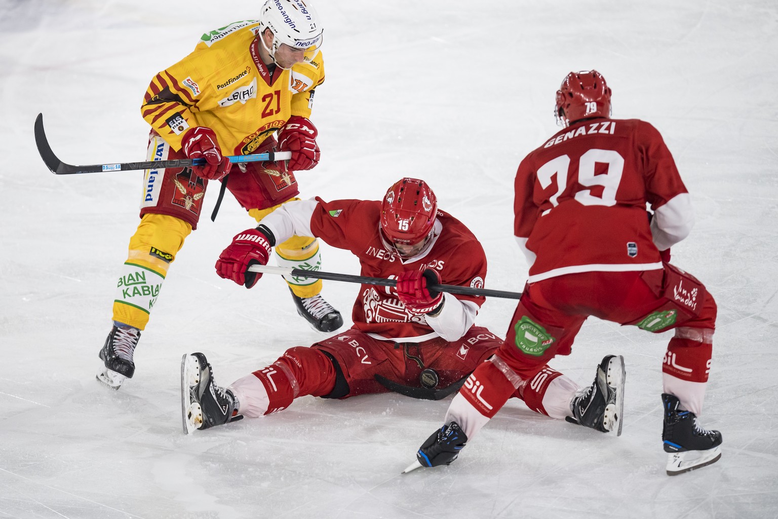 LÕattaquant de Langnau Raphael Kuonen, gauche, lutte pour le puck avec l&#039;attaquant lausannois Dustin Jeffrey, centre, le defenseur lausannois Joel Genazzi, droite, lors du cinquieme match du quar ...