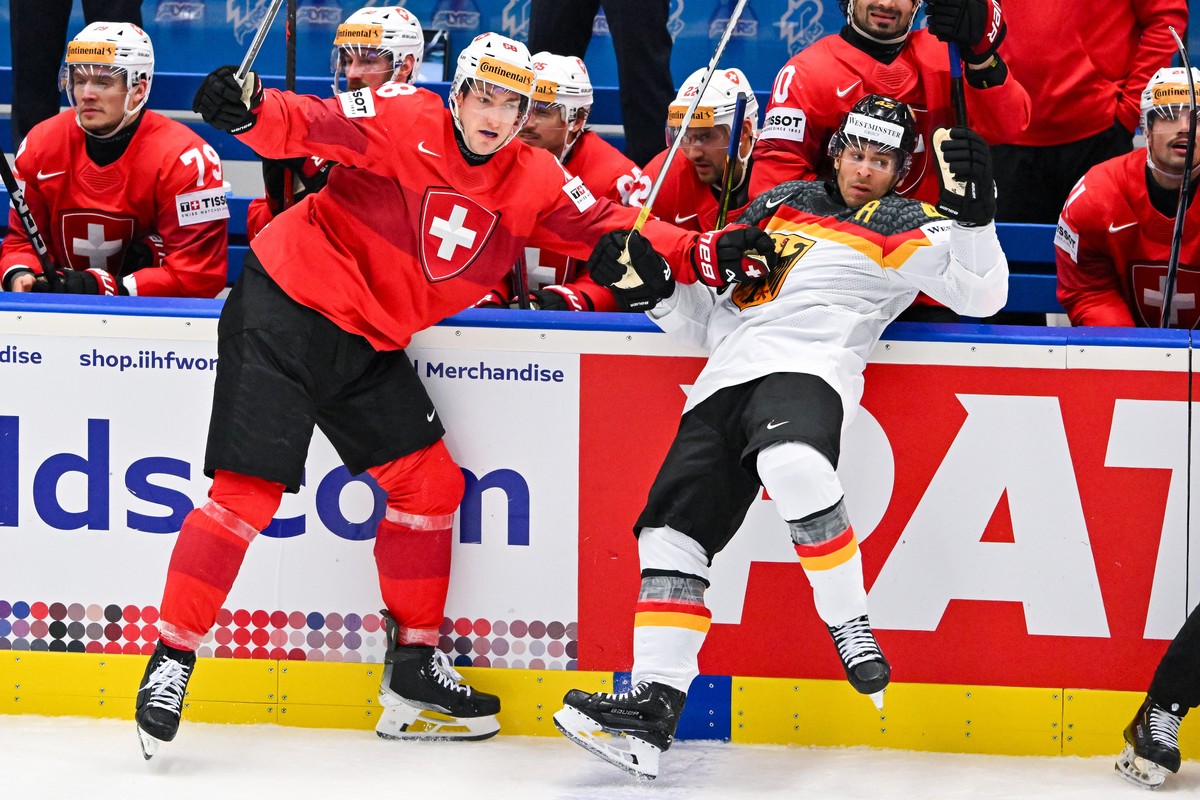 epa11364145 Fabrice Herzog of Switzerland (L) in action against Yasin Ehliz of Germany (R) during the IIHF Ice Hockey World Championship 2024 quarter-final match between Switzerland and Germany, in Os ...