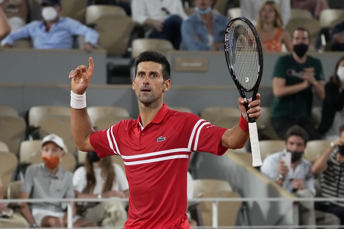 Serbia's Novak Djokovic reacts as he wins the third set against Spain's Rafael Nadal during their semifinal match of the French Open tennis tournament at the Roland Garros stadium Friday, Ju ...