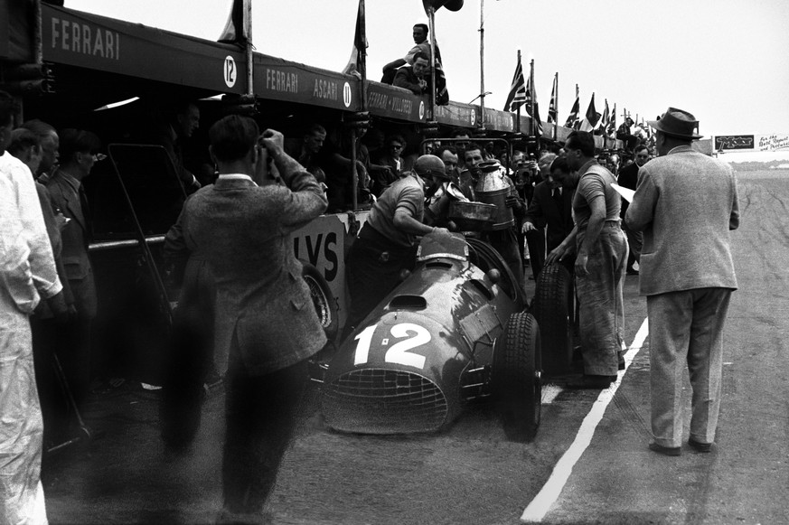 Silverstone, Great Britain. 14 July 1951. Jose Froilan Gonzalez (Ferrari 375), 1st position. Teammate Alberto Ascari looks on as Gonzalez s winning car makes a pit stop. This was Ferrari s first GP vi ...