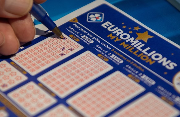 epa08862321 A person plays a EuroMillions grid in Bordeaux, France, 04 December 2020. The jackpot for this draw will reach 200 million euro. Before 2020, the jackpot was capped at 190 million euros. E ...