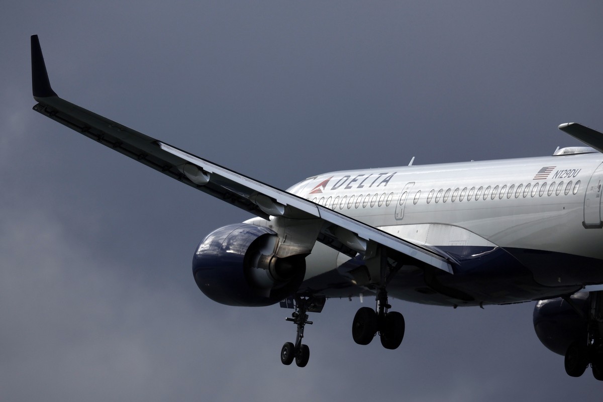 FILE - A Delta Air Lines plane lands at Logan International Airport, Jan. 26, 2023, in Boston. On Thursday, July 11, 2024, Delta Air Lines said its second-quarter profit is down 29% from a year earlie ...