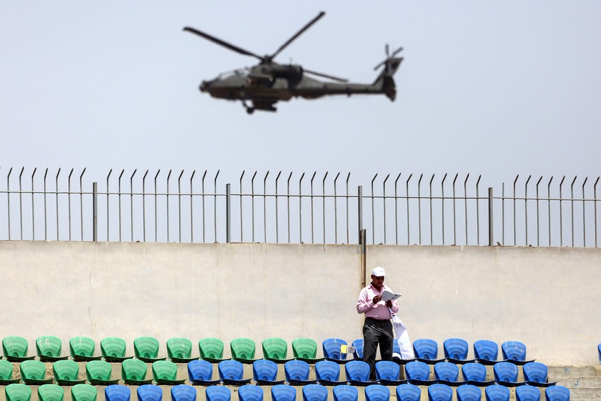 epa05934520 A military helicopter fly over the stadium where Pope Francis celebrates mass at the Air Defense Stadium in Cairo, Egypt, 29 April 2017. Pope Francis is leading a mass in the Air defense s ...