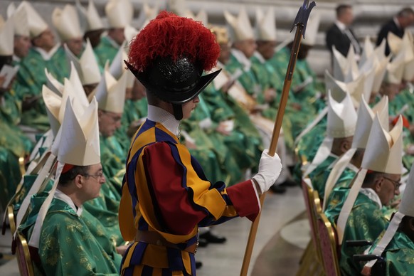 A Vatican Swiss Guard stands at ease during a mass for the new cardinals celebrated by Pope Francis in St. Peter&#039;s Basilica at The Vatican Tuesday, Aug. 30, 2022, that concludes a two-day consist ...