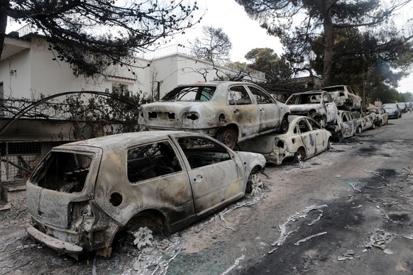 epa06907894 A view of burned cars after a fire in Argyra Akti, Mati, close to Nea Makri, in Attica, Greece, 24 July 2018. At least 53 people have lost their lives in wildfires that broke out in easter ...