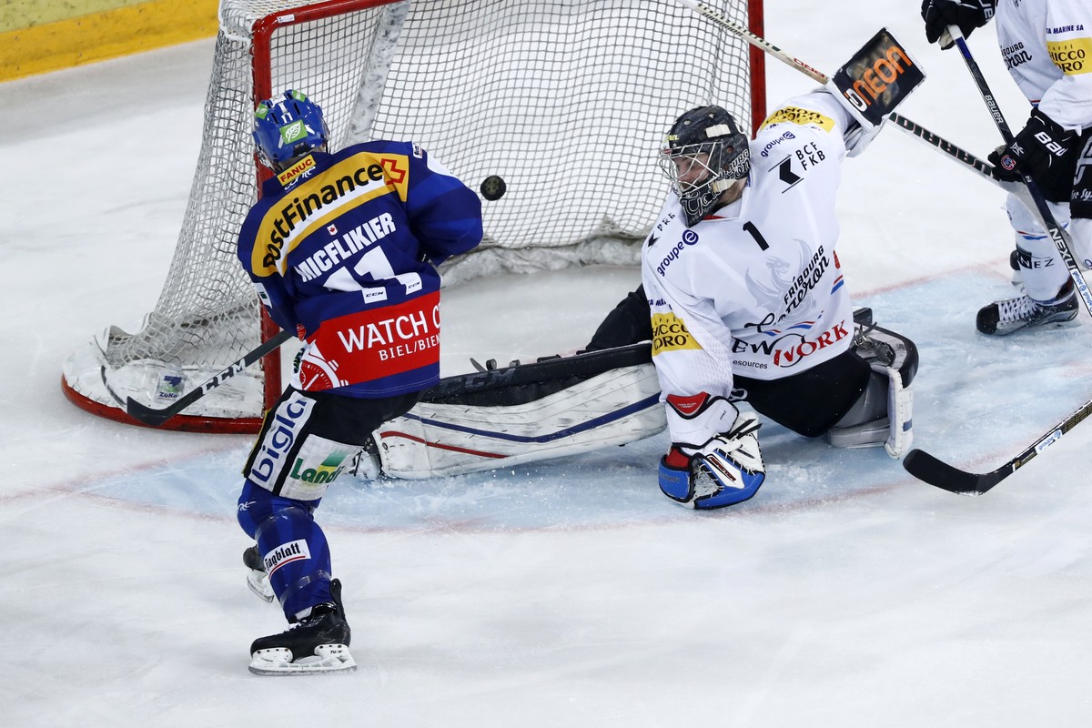 Biels Jacob Micflikier erzielt das Tor zum 2-2 gegen Fribourgs Goalie Benjamin Conz im Eishockey Meisterschaftsspiel der National League A zwischen dem EHC Biel und dem HC Fribourg Gotteron, am Freita ...