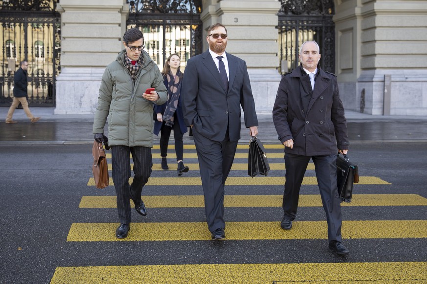 epa07992689 Former head of Guatemala&#039;s national police Erwin Sperisen (C) with his lawyers Florian Baier (R) and Giorgio Campa (L) arrive at the Parliament Buildung &#039;Bundeshaus&#039;, before ...