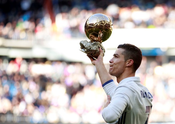 Football Soccer - Real Madrid v Granada - Spanish La Liga Santander - Santiago Bernabeu stadium, Madrid, Spain - 7/1/17 Real Madrid&#039;s Cristiano Ronaldo holds his Ballon d&#039;Or (Golden Ball) tr ...