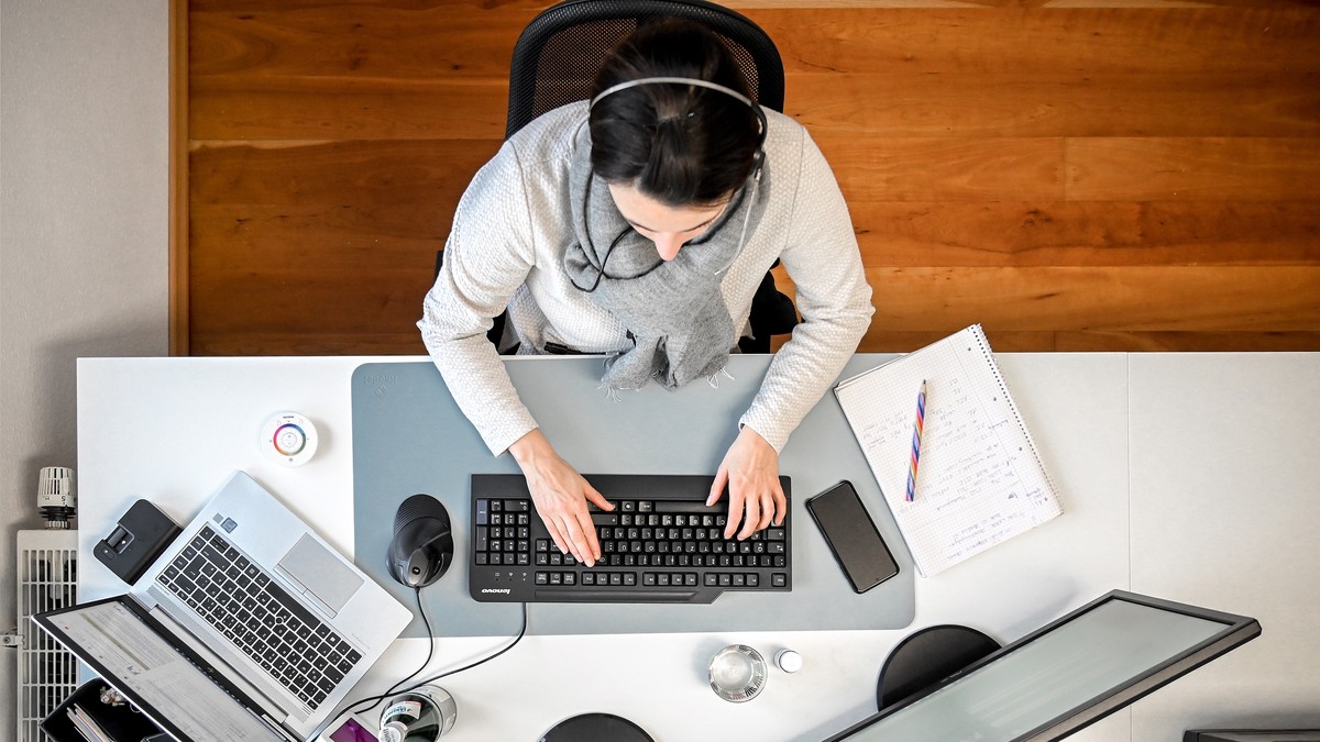 epaselect epa08933122 A woman with a headset sits in front of her computer in the study at home in Moenchengladbach, Germany, 12 January 2021. In view of the fact that the number of corona infections  ...