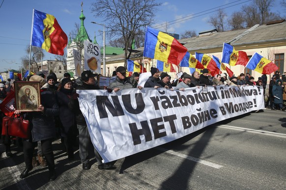 People march with a banner that reads &quot;No to war in Moldova&quot; during a protest initiated by the Movement for the People and members of Moldova&#039;s Russia-friendly Shor Party, against the p ...