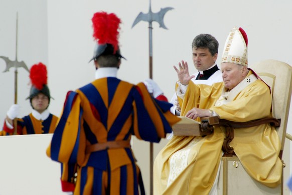 Pope John Paul II waves to the tens of thousands of worshippers after his sermon during an open-air mass in Berne, Switzerland on Sunday, June 6, 2004. The Pontiff has attended a national youth congre ...
