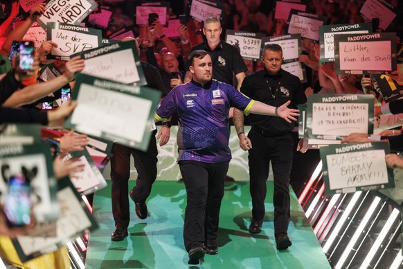epa11054028 Luke Littler of England arrives to play against Rob Cross of England at the semi finals session of the Paddy Power World Darts Championship, in London, Britain, 02 January 2024. EPA/TOLGA  ...