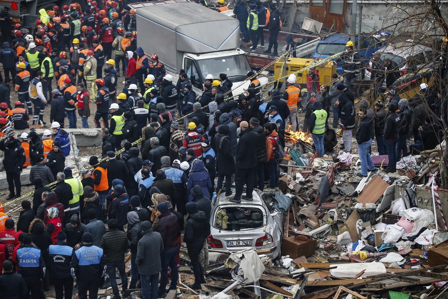 People watch rescue workers searching for survivors in the rubble of an eight-story building which collapsed two days earlier in Istanbul, Friday, Feb. 8, 2019. Turkish rescue workers on Friday pulled ...