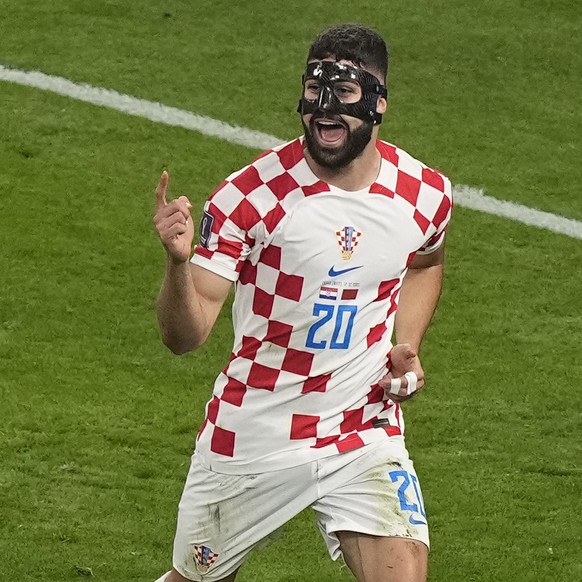 Croatia&#039;s Josko Gvardiol, right, celebrates after scoring his side&#039;s opening goal during the World Cup third-place playoff soccer match between Croatia and Morocco at Khalifa International S ...