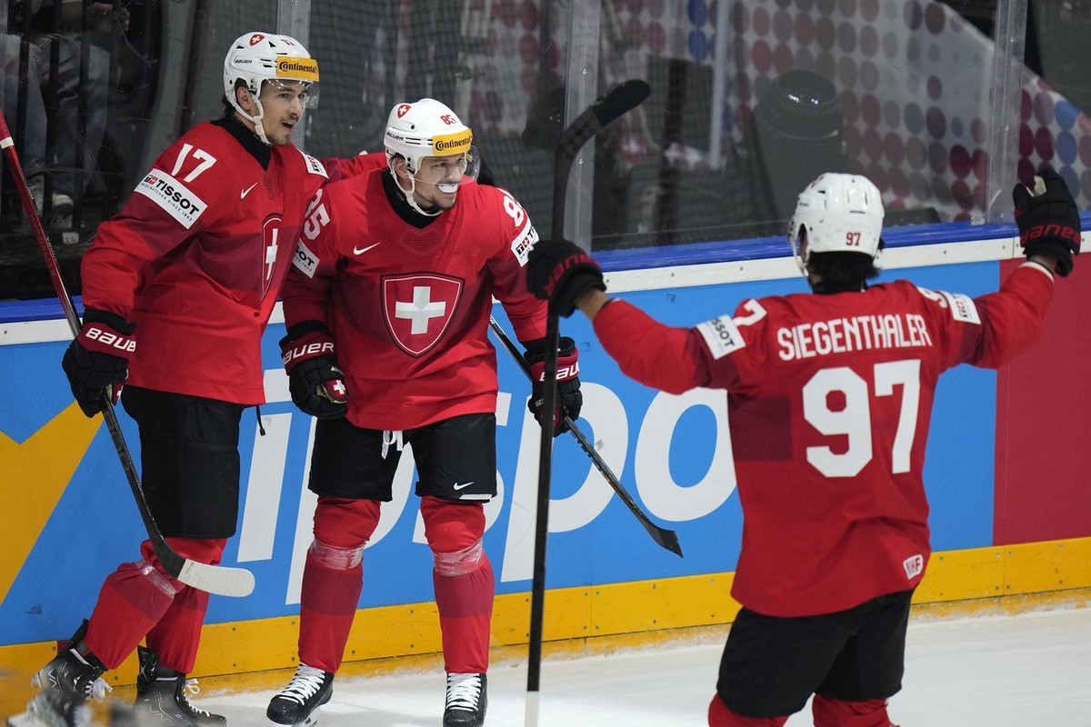 Switzerland's Sven Andrighetto, center, celebrates with teammates after scoring his sides first goal during the preliminary round match between Switzerland and Norway at the Ice Hockey World Cham ...
