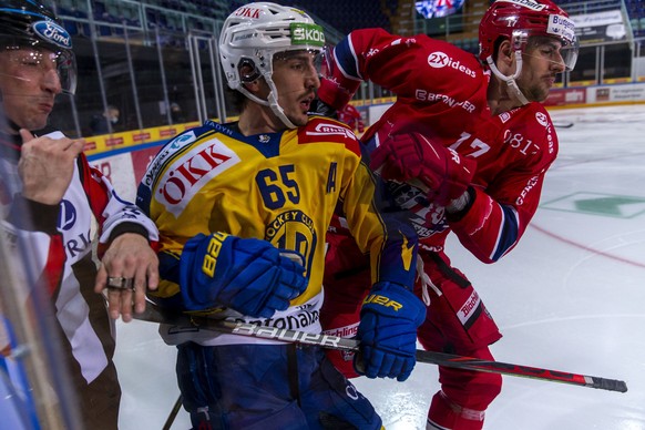 HC Davos Stuermer Marc Wieser, Mitte, gegen SC Rapperswil-Jona Lakers Verteidiger Igor Jelovac waehrend dem Eishockey-Meisterschaftsspiel der National League zwischen den SC Rapperswil-Jona Lakers und ...