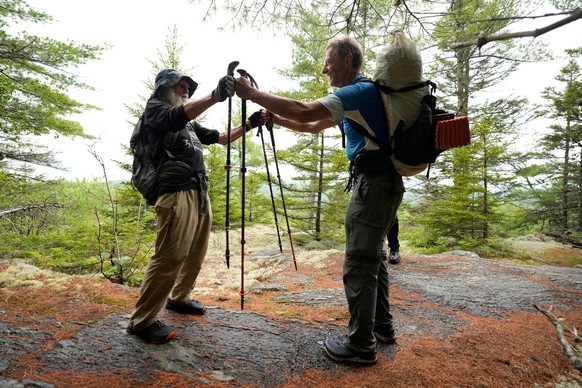 Dale Sanders bumps fists with fellow Appalachian Trail thru-hiker Hans Rechsteiner, south of Maine's Mount Katahdin, Wednesday, July 29, 2026. (AP Photo/Robert F. Bukaty)
Appalachian Trail Oldest ...