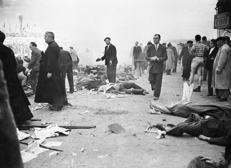 **Eds Note: Graphic Content** With arms outstretched in a helpless gesture, this Frenchman is surrounded by the victims of the racing car accident during the 24-hour endurance race at Le Mans, France  ...