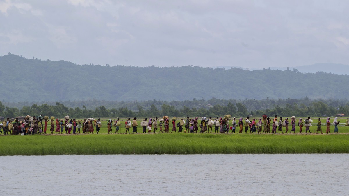 Rohingya Muslims walk towards refugee camps after spending four days in the open, having being earlier prevented by Bangladesh border guards from moving ahead, at Palong Khali, Bangladesh, Thursday, O ...