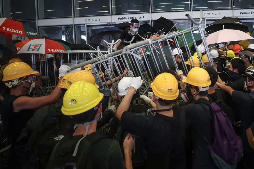 epa07686882 Protesters try to break into the Legislative Council building during the annual 01 July pro-democracy march in Hong Kong, China, 01 July 2019. Protesters are demanding the resignation of H ...