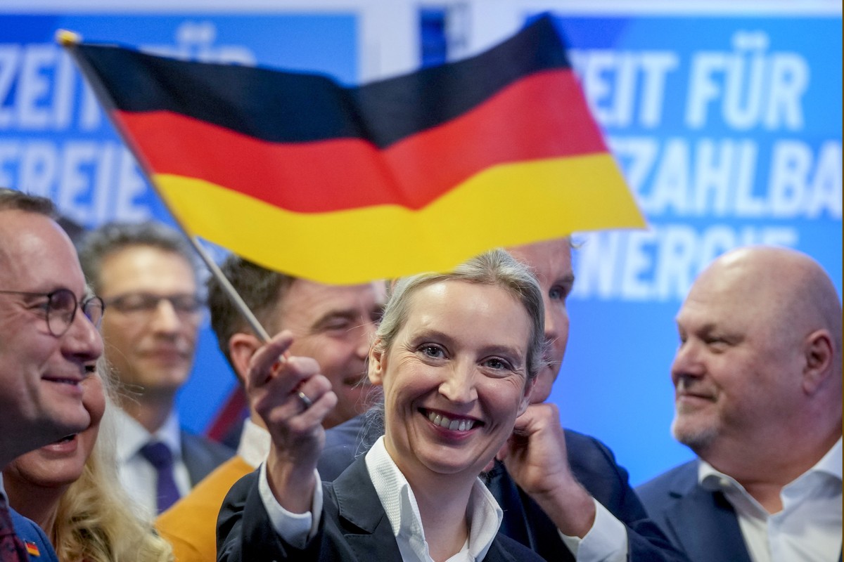 Leader of far right AfD Alice Weidel waves a German flag at the AfD party headquarters in Berlin, Germany, Sunday, Feb. 23, 2025, after the German national election. (AP Photo/Michael Probst)