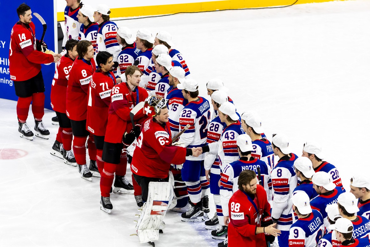 Switzerland's players congratulate the US's players after the victory of the team USA in the gold medal game at the IIHF 2025 World Championship, at the Avicii Arena (Globe), in Stockholm, S ...