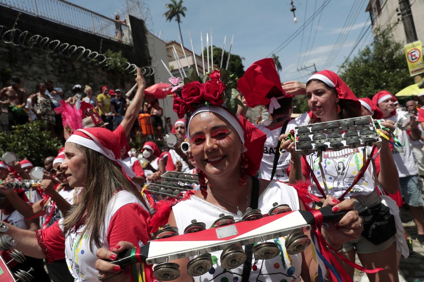 epa10473251 Members of the Carmelitas street troupe participate in an official parade of the Rio de Janeiro Carnival, in the historic neighborhood of Santa Teresa in Rio de Janeiro, Brazil, 17 Februar ...