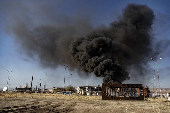 A smoke rises from an oil depot struck by Turkish air force near the town of Qamishli, Syria, Wednesday, Nov. 23, 2022. Turkey&#039;s president says he will carry out a land invasion into Kurdish area ...
