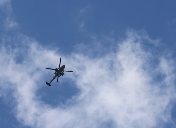 epa11162929 A helicopter flies over the refugee camp in the West Bank city of Tulkarem during a raid carried out by Israeli forces, 18 February 2024. At least three Palestianians were injured during c ...