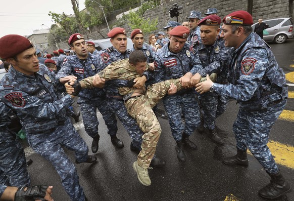 Police detain a demonstrator during a protest rally, in Yerevan, Armenia, Monday, May 2, 2022. Police in Armenia&#039;s capital on Monday detained 125 anti-government demonstrators that were blocking  ...