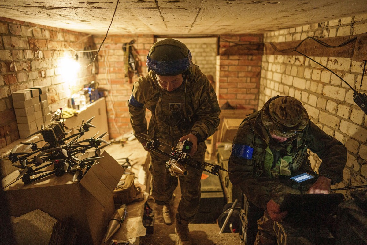 A Ukrainian soldier, aka Manul, of the ACHILLES battalion of the 92nd brigade, carries a suicide FPV drone to the take-off position before flight over Russian positions in Kharkiv region, Ukraine, Mon ...