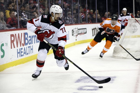 New Jersey Devils defenseman Jonas Siegenthaler (71) looks to pass the puck in front of Philadelphia Flyers right wing Wade Allison during the third period of an NHL hockey game Saturday, Feb. 25, 202 ...