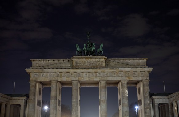 epa07474354 View of the Brandenburg Gate with its lights turned off to mark Earth Hour in Berlin, Germany, 30 March 2019. Many landmark buildings across Germany switched off their lights for one hour  ...